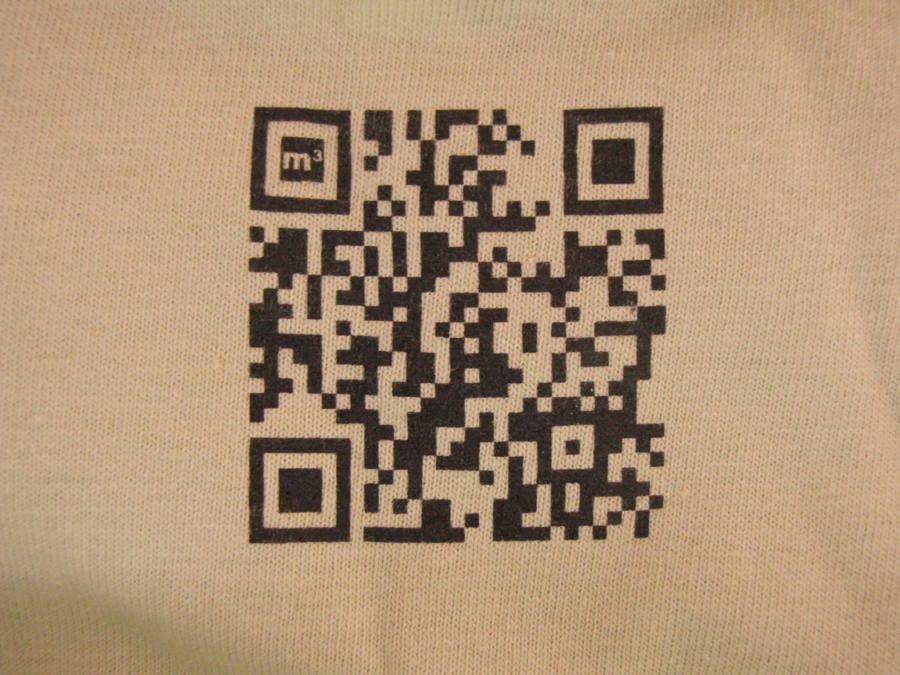 Close-up of a QR code printed on fabric — the Mobile Marketing Max branded code that linked to the company website.